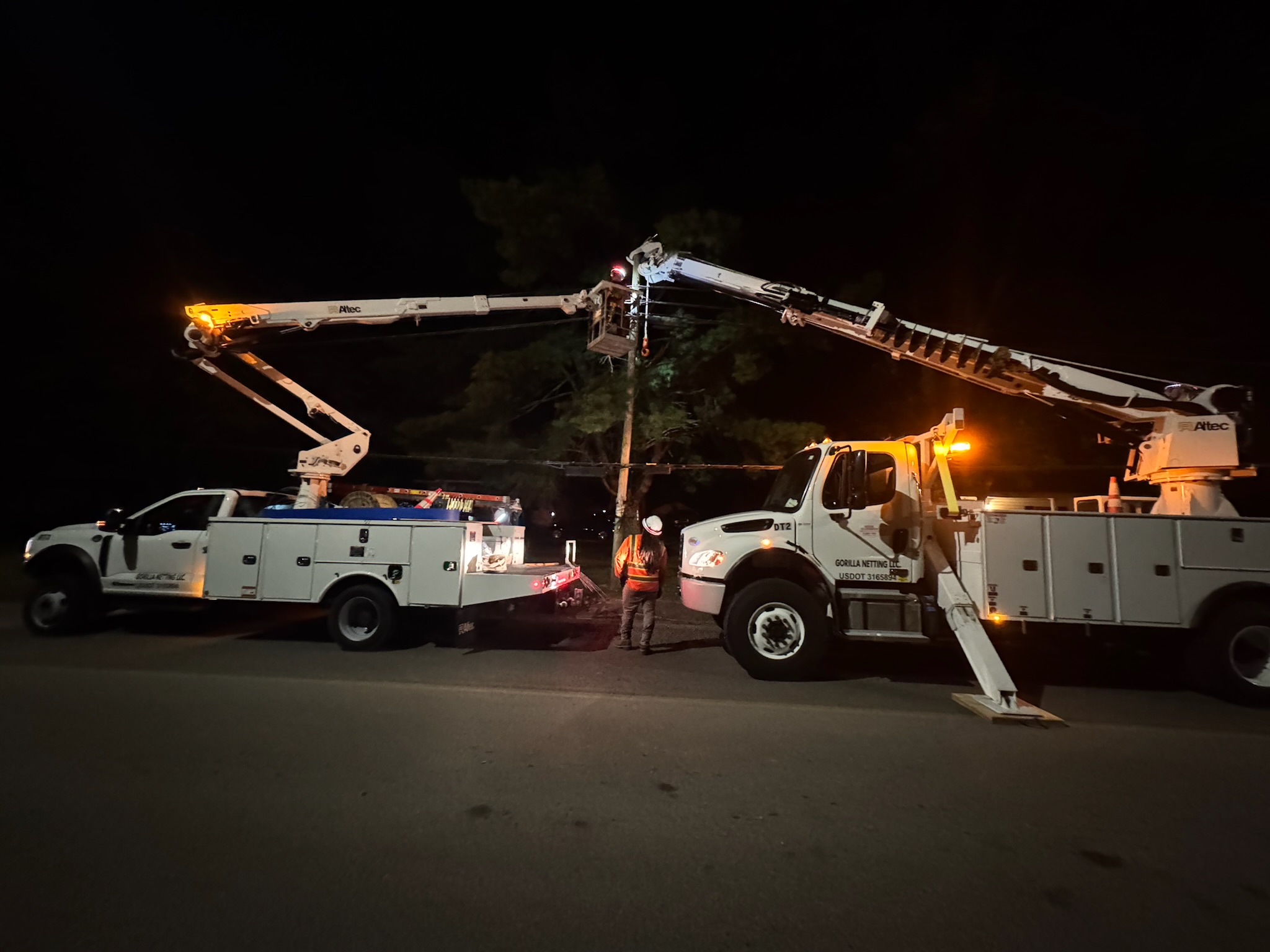Gorilla Communications crews working at night with bucket trucks